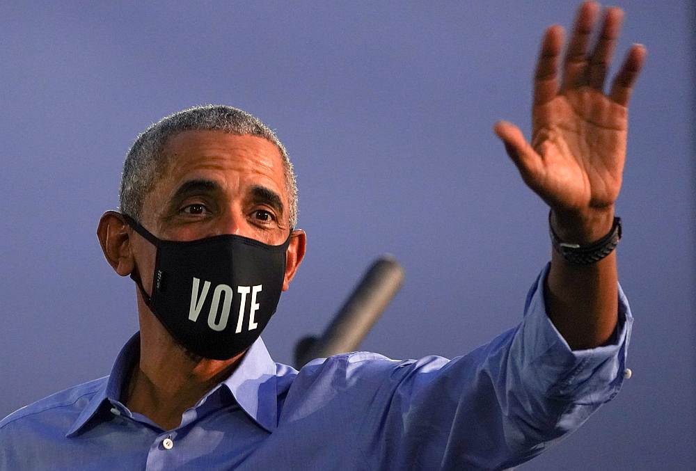 Former US President Barack Obama waves while wearing a 'Vote' mask as he campaigns on behalf of Democratic presidential nominee Joe Biden in Philadelphia, Pennsylvania October 21, 2020. u00e2u20acu201d Reuters pic