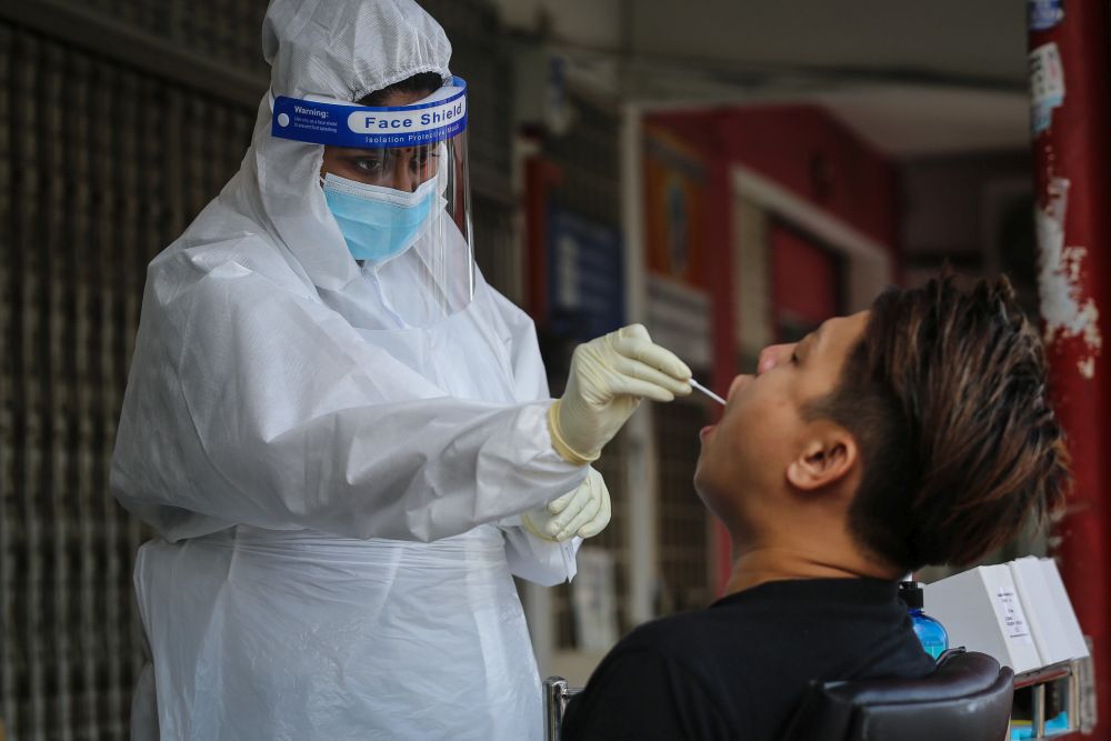 A healthcare worker collects swab samples to test for Covid-19 at BP Healthcare in Klang October 27, 2020. u00e2u20acu201d Picture by Yusof Mat Isa