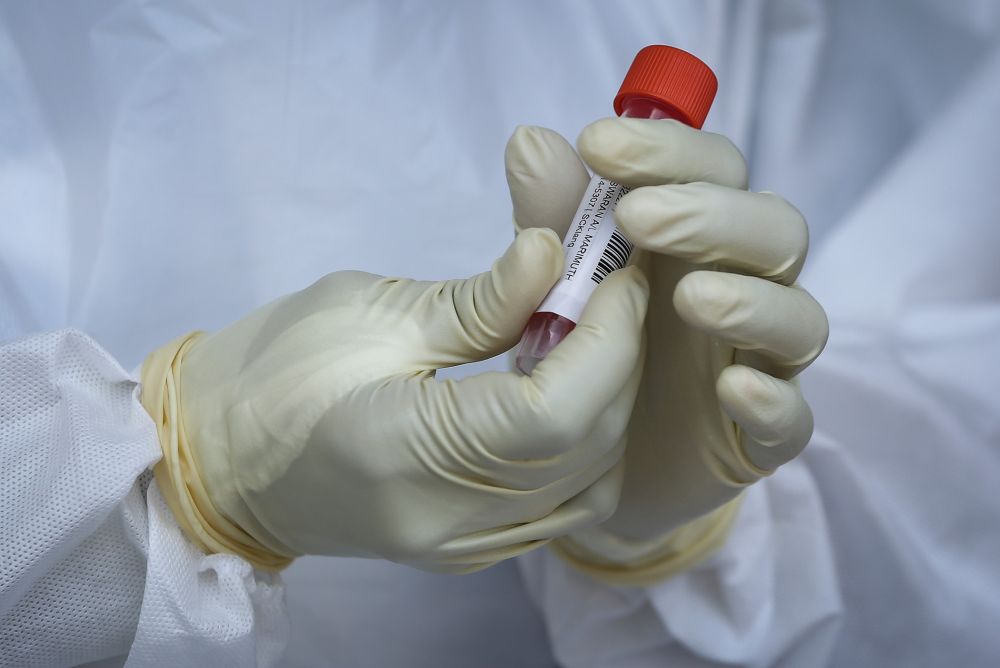 A healthcare worker collects swab samples to test for Covid-19 at BP Healthcare in Klang October 27, 2020. u00e2u20acu201d Picture by Yusof Mat Isa