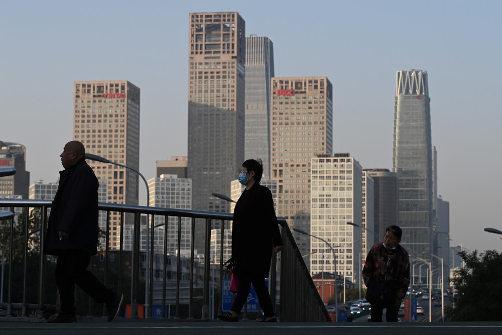 People walk on a pedestrian overpass in Beijing October 29, 2020. u00e2u20acu201d AFP pic 