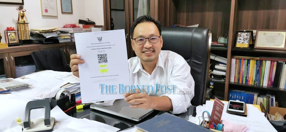 DAP Sarawak chairman Chong Chieng Jen shows his e-health declaration form which he said he filled up as per the SOP. He had recently gotten his test results, which turned out to be negative for the virus. u00e2u20acu201d Borneo Post pic