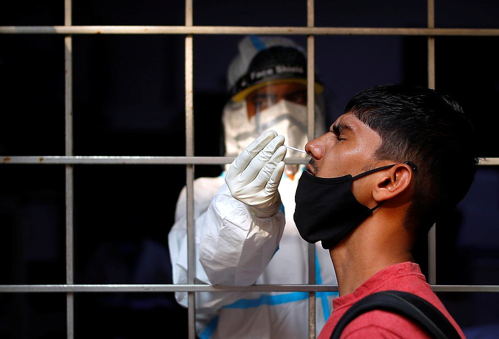 nA man reacts as a healthcare worker collects a swab sample amid the spread of the Covid-19, at a testing centre, in New Delhi, India October 17, 2020. u00e2u20acu201d Reuters pic