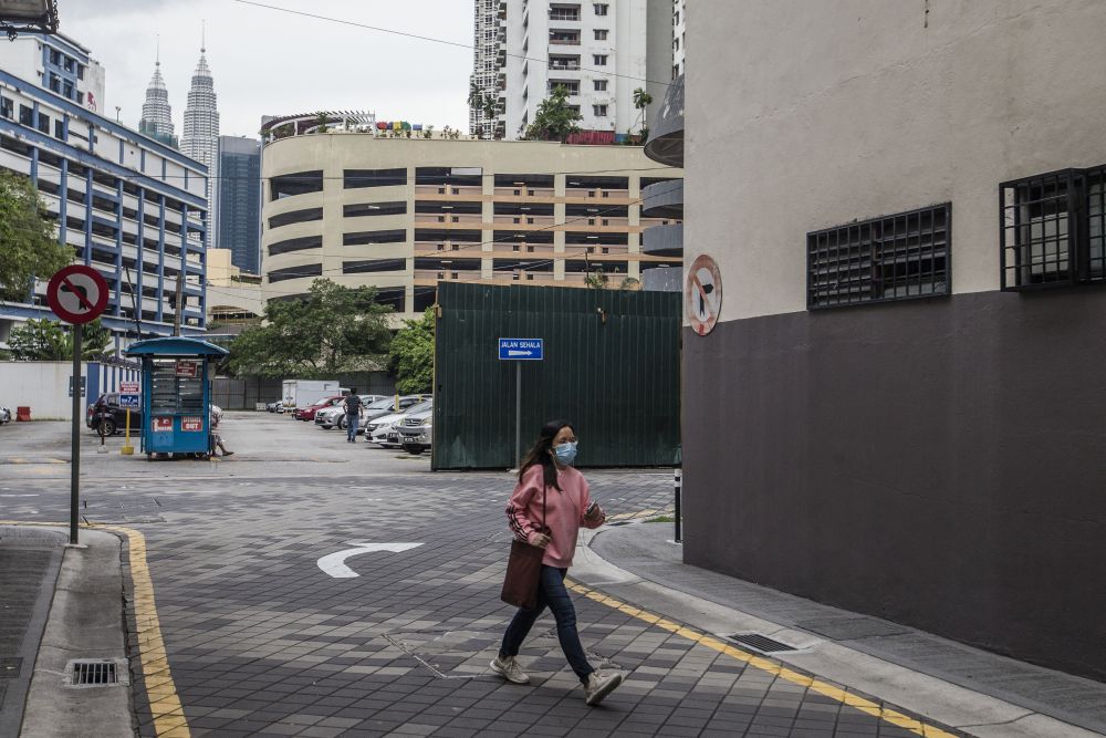 A woman is seen walking along Jalan Tuanku Abdul Rahman amid the conditional movement control order in Kuala Lumpur October 23, 2020. u00e2u20acu201d Picture by Firdaus Latif