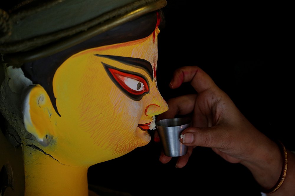 A woman performs rituals with an idol at a 'pandal' or a temporary platform, on the last day of Durga Puja festival, amid the Covid-19 outbreak, in Kolkata, India October 26, 2020. u00e2u20acu201d Reuters pic