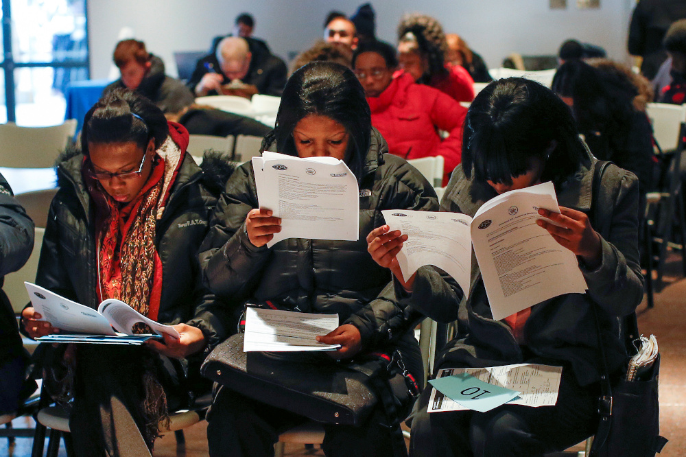 People fill out application forms before a screening session for seasonal jobs at Coney Island in the Brooklyn borough of New York March 4, 2014. u00e2u20acu201d Reuters pic