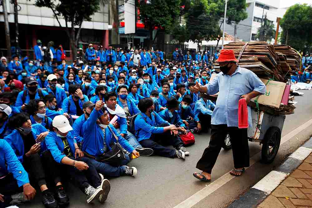 nA university student gestures to a man pushing a chart while resting on a main road to protest the government's proposed labour reforms in a controversial bill in Jakarta, Indonesia, October 8, 2020. u00e2u20acu201d Reuters pic