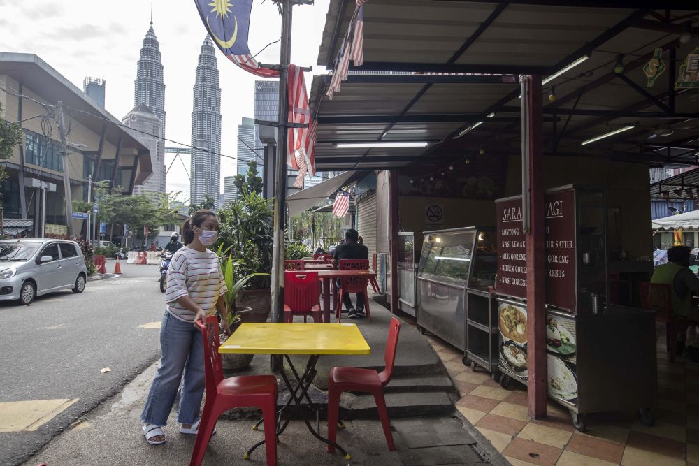 Warung Perasan owner Safinaz arranges chairs at her eatery in Kampung Baru, Kuala Lumpur October 27, 2020. u00e2u20acu201d Picture by Firdaus Latif