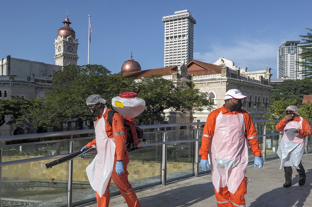 A worker sprays disinfectant at public areas to curb the spread of Covid-19 in Kuala Lumpur October 16, 2020. u00e2u20acu2022 Picture by Shafwan Zaidon
