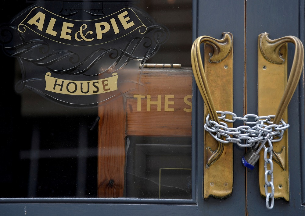 A chain and padlock are seen on the doors of a shut pub, amid the spread of the coronavirus disease in London. u00e2u20acu2022 Reuters file pic
