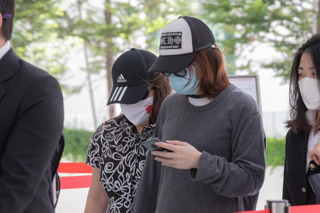 Lucy Teo (third from right) and her daughter Sharon Loo (second from right) were jailed for taking a bribe from a woman who wanted Teo to help her speed up her application for a Singaporean permanent residency. u00e2u20acu201d TODAY pic