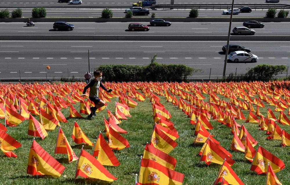 A boy runs among thousands of Spanish flags, representing the Spanish victims of Covid-19, in the Roma park in Madrid, on September 27, 2020. u00e2u20acu201d AFP pic