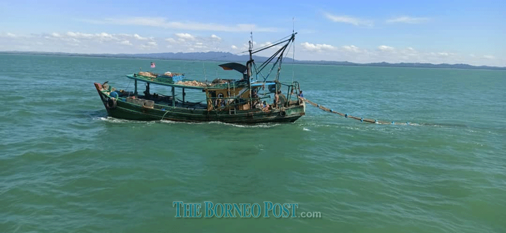 The local fishing boat detained for encroaching into a restricted fishing zone. u00e2u20acu2022 Borneo Post pic