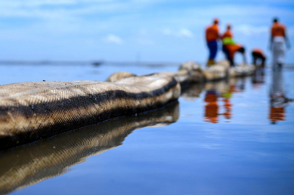 Absorbent booms are used to absorb the oil from the spill during cleaning work carried out in the mangrove area in Tanjung Tuan, October 18, 2020. u00e2u20acu201d Bernama pic 