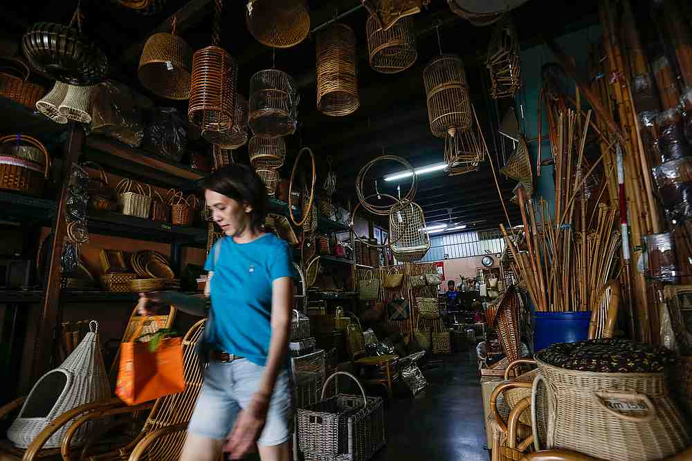 A woman walk passed the Rattan furniture here at Seang Hin Leong Rattan shop at Lebuh Pantai. — Picture by Sayuti Zainudin
