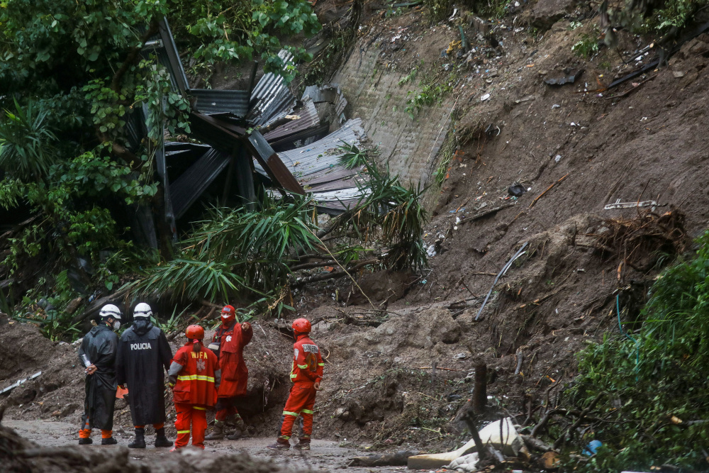 Rescuers stand at the site where seven people went missing after a mudslide caused by constant rains, in Santo Tomas, El Salvador June 4, 2020. u00e2u20acu201d Reuters pic