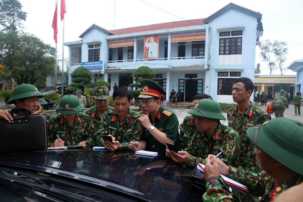 Military personnel, part of the rescue team, are deployed to search for missing people at a site of a landslide near a hydropower dam in Thua Thien Hue province October 14, 2020. u00e2u20acu201d Tran Le Lam/VNA via Reuters