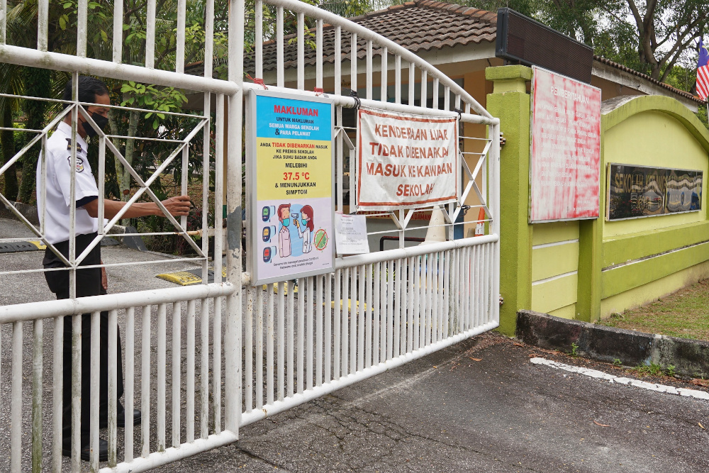 A security guard closes the main gate of a school in Seksyen 11 Petaling Jaya after the Ministry of Education orders to close all school in Selangor for two weeks October 12, 2020. u00e2u20acu201d Picture by Ahmad Zamzahuri