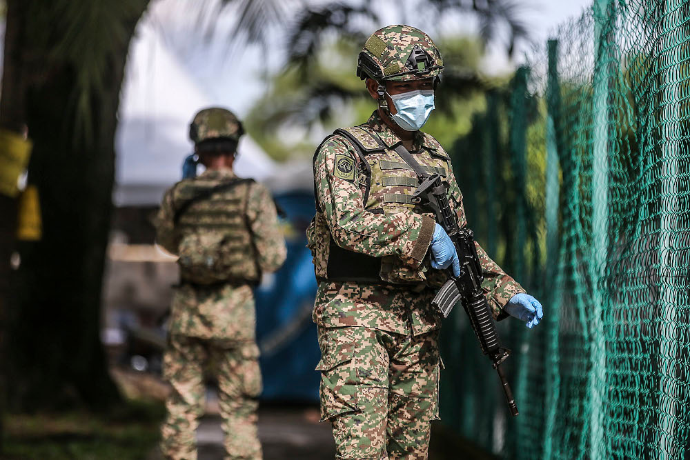 Armed Forces personnel and police guard the Tropicana Golf and Country Resortu00e2u20acu2122s hostel in Petaling Jaya October 12, 2020. u00e2u20acu201d Picture by Ahmad Zamzahuri