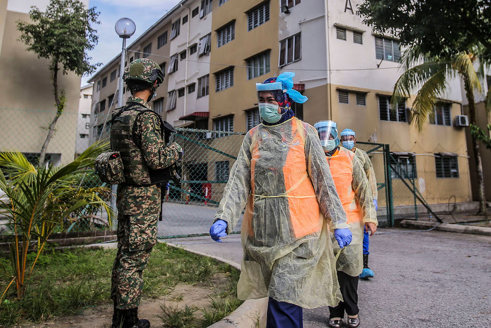 Armed Forces personnel and police guard the Tropicana Golf and Country Resortu00e2u20acu2122s hostel in Petaling Jaya October 12, 2020. u00e2u20acu201d Picture by Ahmad Zamzahuri