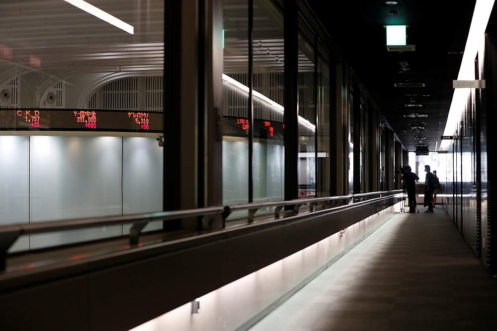 A TV crew film monitors showing respective company's stock prices at the Tokyo Stock Exchange in Tokyo, Japan October 2, 2020. u00e2u20acu201d Reuters pic