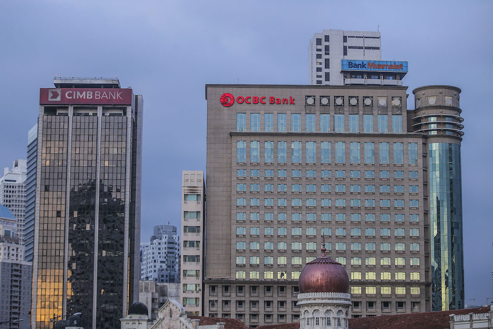 The logos of OCBC, Bank Muamalat and CIMB are seen in Kuala Lumpur November 3, 2020. u00e2u20acu201d Picture by Hari Anggara