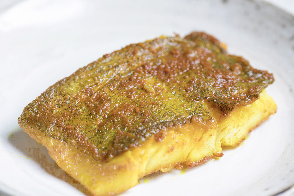 The crispy, turmeric-flavoured skin is the best part of the fish.