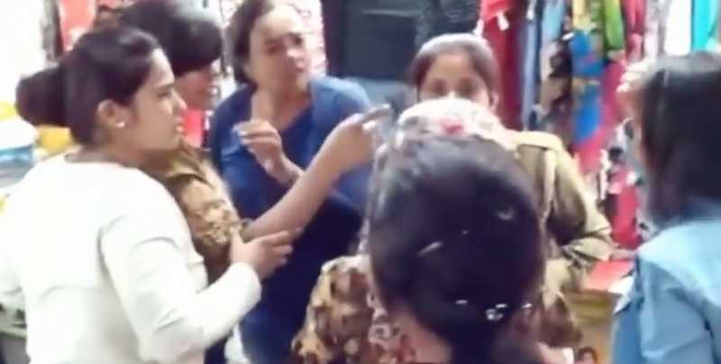 Photo 1 - Several bystanders tried to pull the duo apart before the police came to break up the fight. u00e2u20acu201d Screengrab from YouTube/Pakistan Latest