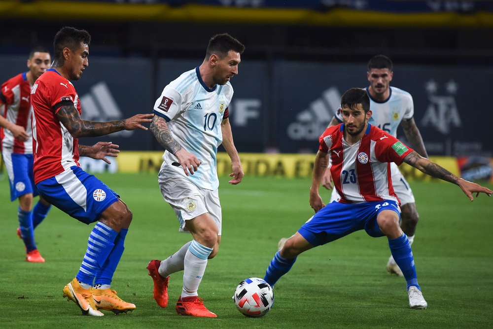 Argentinau00e2u20acu2122s Lionel Messi (centre) in action with Paraguayu00e2u20acu2122s Mathias Villasanti during the match between Argentina and Paraguay at the Estadio La Bombonera in Beuns Aires November 12, 2020. u00e2u20acu201d Pool pic via Reuters