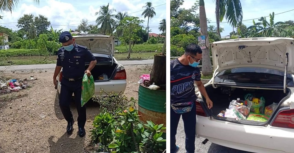 Alor Janggus police officers distributing food items to a family of seven. u00e2u20acu201d  Picture via Facebook/BalaiPolisAlorJanggus,Kedah