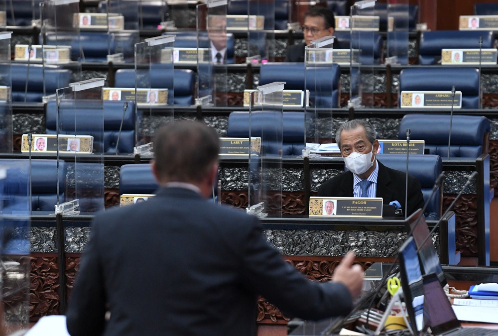 Prime Minister Tan Sri Muhyiddin Yassin (right) looks on as Opposition Leader Datuk Seri Anwar Ibrahim (left) speaks at the Parliament in Kuala Lumpur November 9, 2020. u00e2u20acu201d Bernama pic