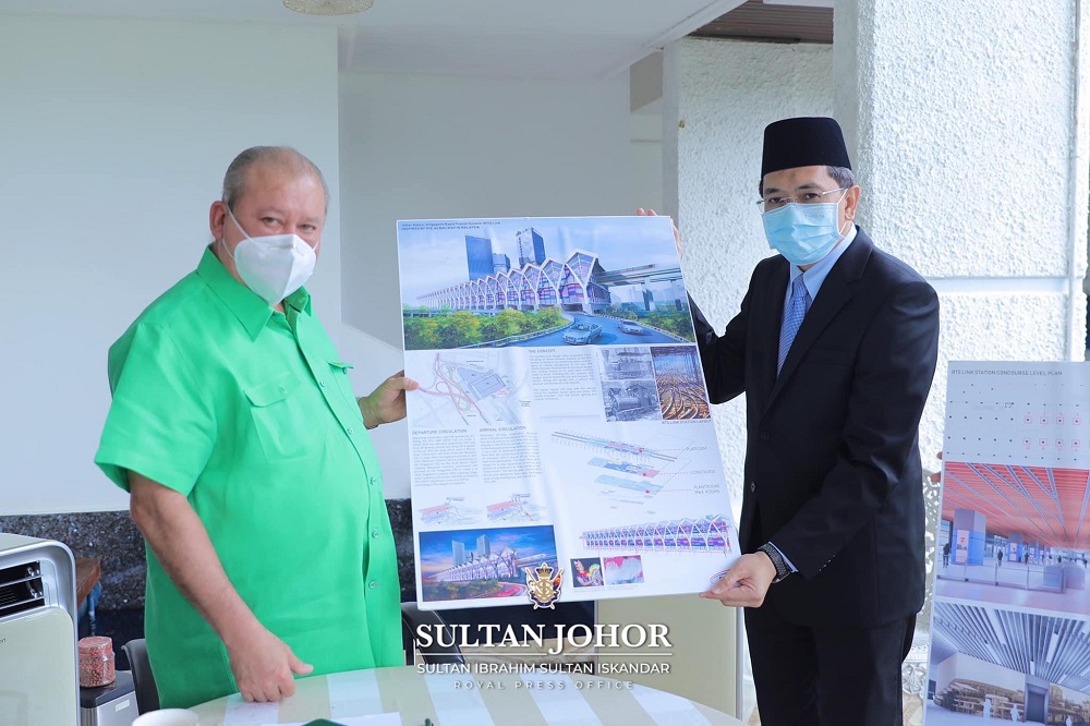 Sultan Ibrahim Sultan Iskandar (left) holding up images for the Johor Baru-Singapore Rapid Transit System project after being briefed on the project that is set to be virtually launched on November 22, in conjunction with his birthday. u00e2u20acu201d Picture via Fac