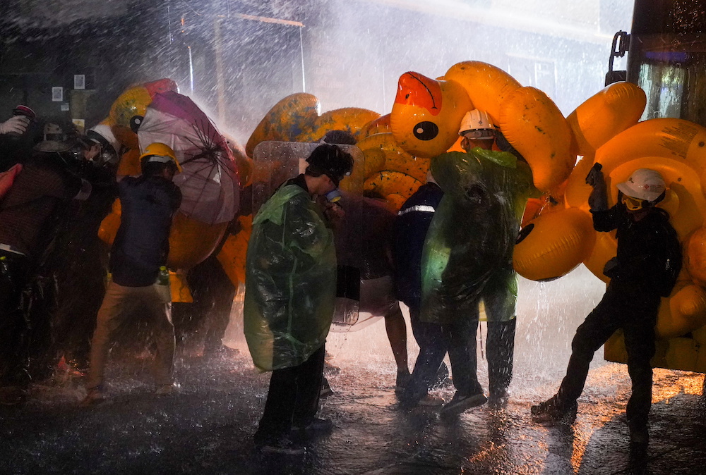 Demonstrators use inflatable rubber ducks as shields to protect themselves from water cannons during an anti-government protest as lawmakers debate on constitution change, outside the parliament in Bangkok, Thailand, November 17, 2020. u00e2u20acu201d Reuters pic