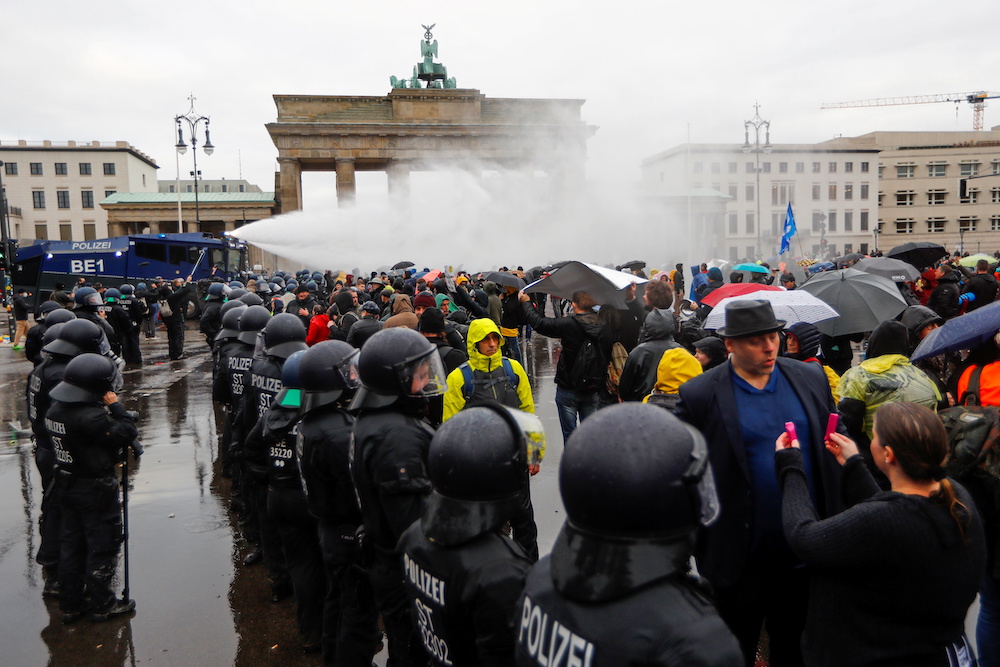 Demonstrators are sprayed with a water cannon during a protest against the government's coronavirus disease (Covid-19) restrictions, next to the Brandenburger Gate in Berlin, November, 18, 2020. u00e2u20acu201d Reuters pic