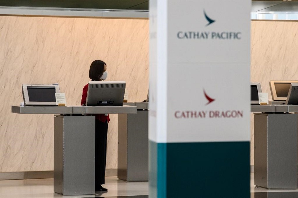 An employee waits for customers at a counter for Cathay Pacific and Cathay Dragon at Hong Kong International Airport October 20, 2020. u00e2u20acu201d AFP pic