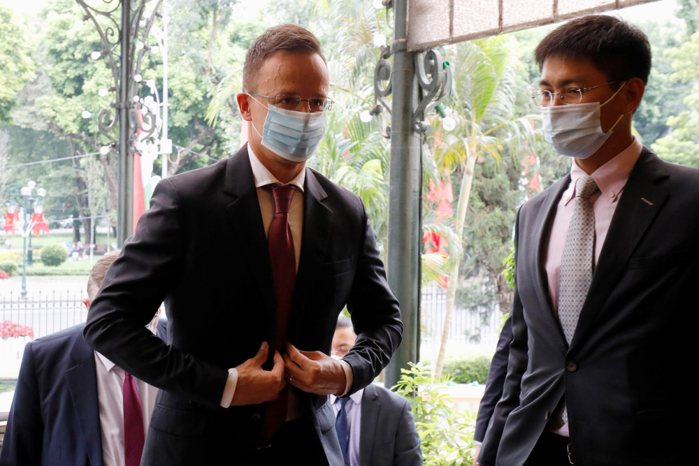 Hungaryu00e2u20acu2122s Foreign Minister Peter Szijjarto (left) wearing protective face mask, arrives for a meeting with his Vietnamese counterpart Pham Binh Minh in Hanoi, Vietnam October 16, 2020. u00e2u20acu201d Reuters pic