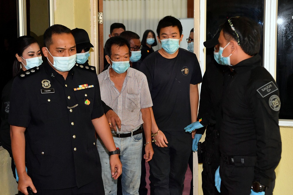 Chai Kin Sang (fourth left) and his son, Chai Wern Teik (second right), are led to the Selayang Sessions Court in Kuala Lumpur November 3, 2020. u00e2u20acu201d Bernama pic