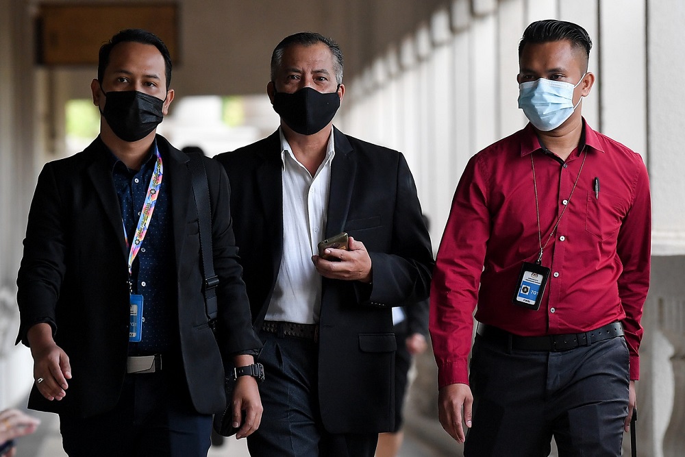 Lieutenant Colonel Azman Mohamed Yasin (centre) arrives at the Sessions Court in Kuala Lumpur November 23, 2020. u00e2u20acu201d Bernama pic