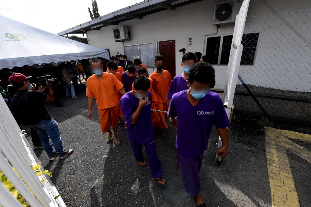 The suspects are led out of the Kangar Magistrate Court November 25, 2020. u00e2u20acu201d Bernama pic