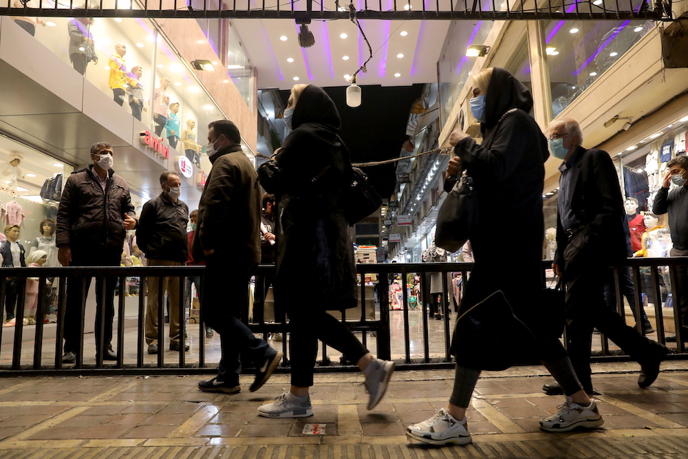 Iranian people wearing protective masks as they walk at a store, amid the outbreak of the coronavirus disease, in Tehran, Iran November 11, 2020. u00e2u20acu2022 Reuters pic