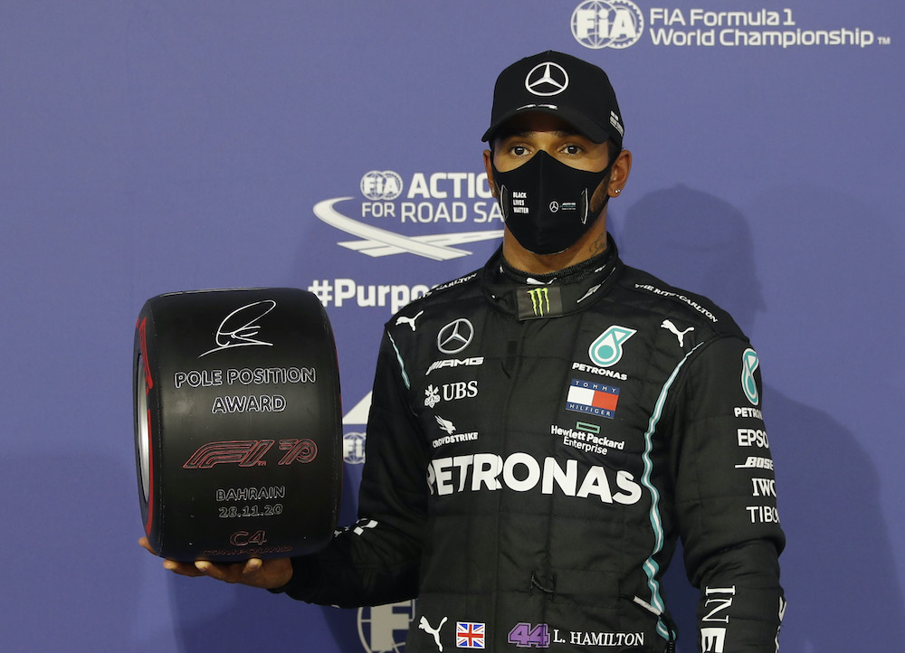 Mercedesu00e2u20acu2122 Lewis Hamilton celebrates with an award after qualifying in pole position at the Bahrain International Circuit in Sakhir, Bahrain, November 28, 2020. u00e2u20acu201d Reuters picnn