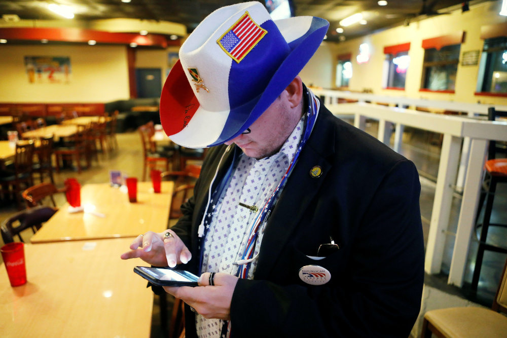 John Carroll, a member of the Republican Liberty Caucus checks for 2020 US presidential election results on his phone before leaving the President Donald Trump 2020 watch party in Largo, Florida, November 4, 2020. u00e2u20acu201d Reuters pic 
