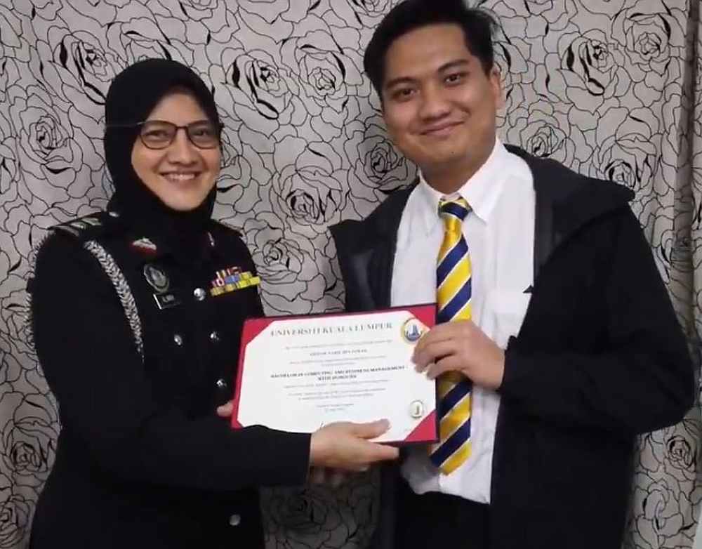 Ahmad Nabil (right) receiving his graduation certificate from his mother in his creative home convocation ceremony. u00e2u20acu201d Twitter/AhmadNabil
