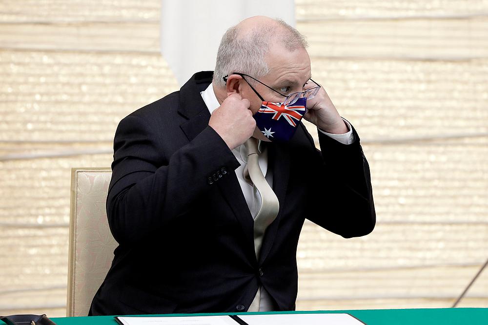 Scott Morrison, Australia's prime minister, removes his protective face mask after arriving for a signing ceremony at the Japan Prime Minister YoshihideSuga's official residence in Tokyo, Japan November 17, 2020. u00e2u20acu201d Pool pic via Reuters