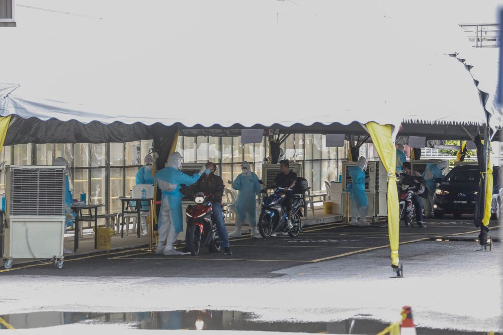 Health workers collect swabs at a Covid-19 drive-through testing site at a factory in the Bayan Lepas Industrial Zone  November 12, 2020. u00e2u20acu201d Picture by Sayuti Zainudin