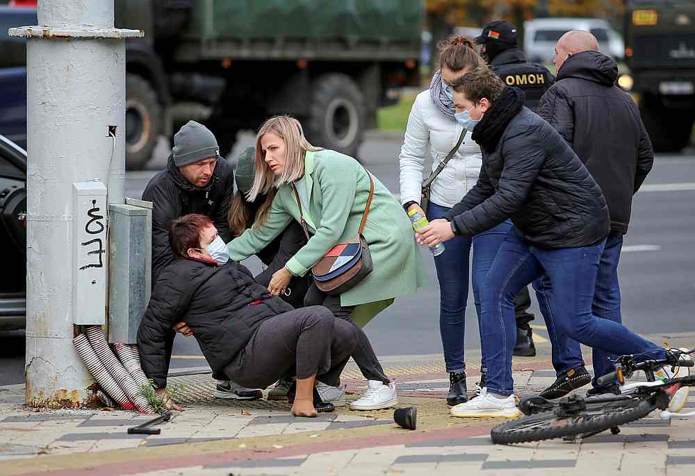 People assist a woman after she collided with a law enforcement officer during a rally of opposition supporters to reject the presidential election results in Minsk, Belarus November 1, 2020. u00e2u20acu201d Reuters pic