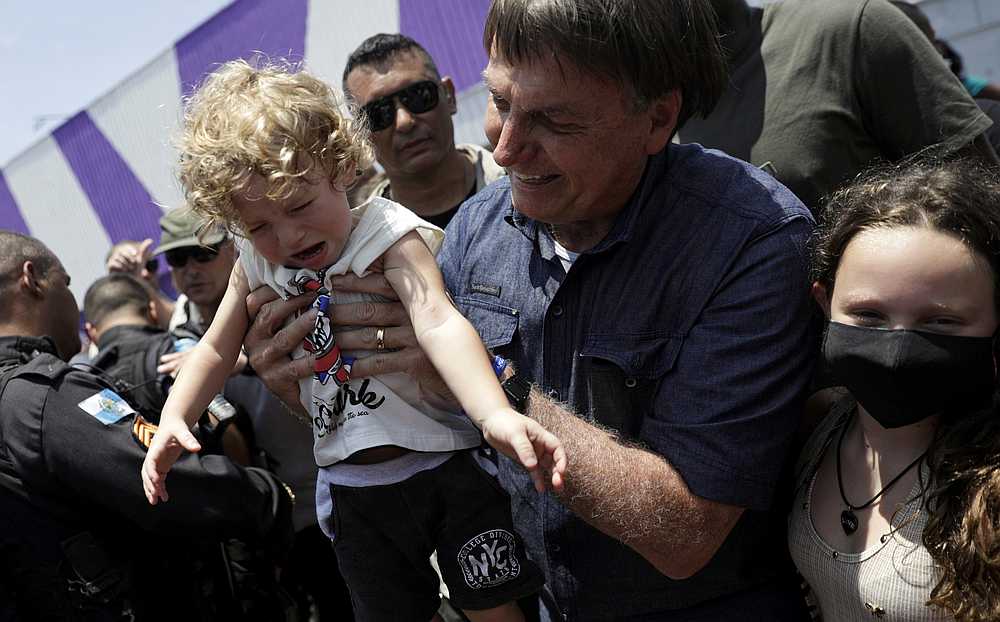 Brazil's President Jair Bolsonaro lifts a child after he voted during the municipal elections in Rio de Janeiro, Brazil November 15, 2020. u00e2u20acu201d Reuters pic