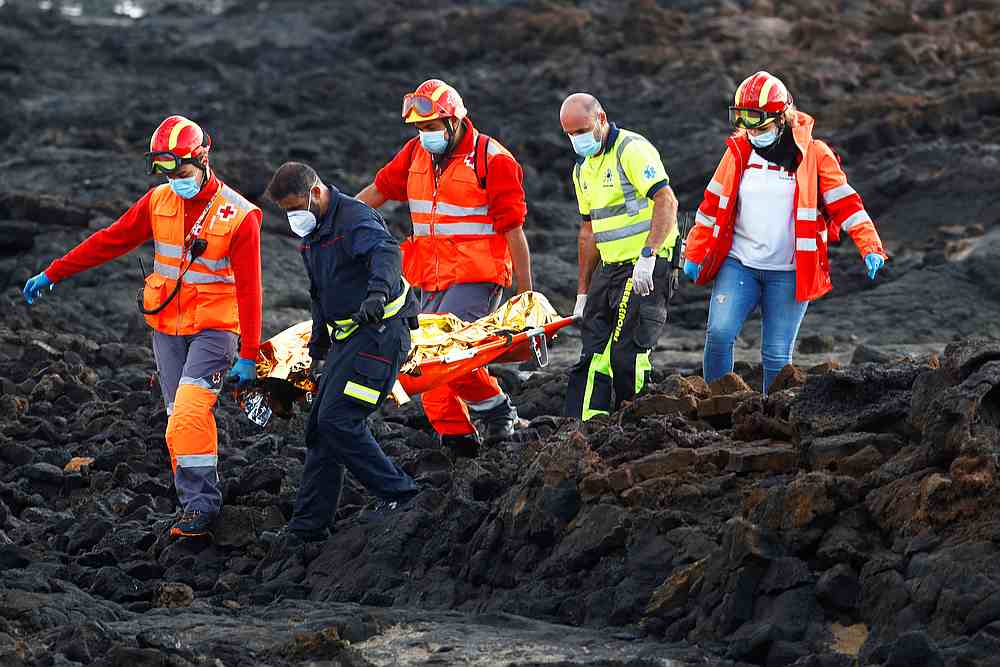 Rescue workers carry the body of a dead migrant after a boat with 35 migrants from the Maghreb region capsized in the beach of Orzola, in the Canary Island of Lanzarote, Spain November 25, 2020. u00e2u20acu201d Reuters pic