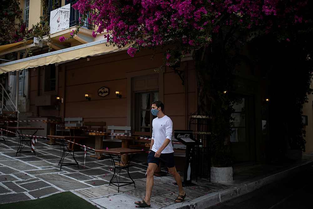 A man wearing a protective face mask makes his way next to a closed restaurant in Plaka district, amid the Covid-19 pandemic, in Athens, Greece November 3, 2020. u00e2u20acu201d Reuters pic