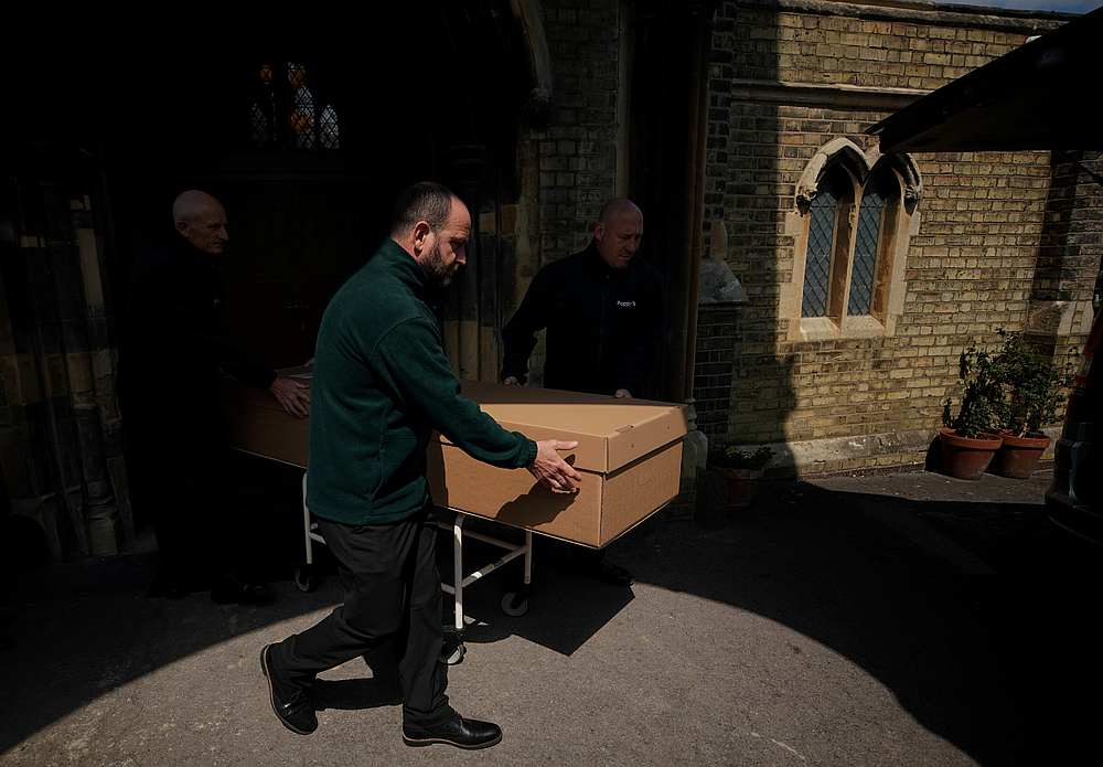 Mortuary workers push a coffin containing the body of a deceased person to a hearse at Poppy's Funerals in Lambeth Cemetery, as the spread of Covid-19 continues in London, Britain May 4, 2020. u00e2u20acu201d Reuters pic