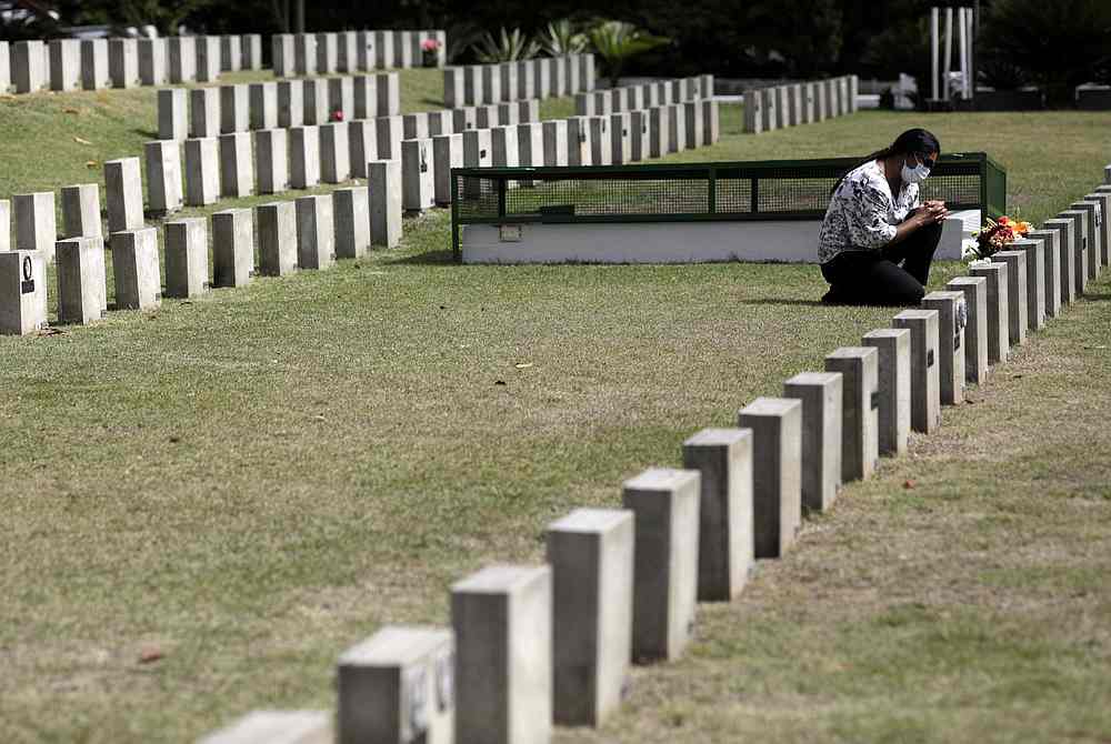 A woman reacts during the celebrations of the Day of the Dead, amid the Covid-19 pandemic, at Penitencia cemetery in Rio de Janeiro, Brazil November 2, 2020. u00e2u20acu201d Reuters pic